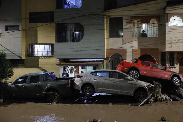 This view shows cars affected by flooding caused by heavy rains in the Yanahuara district of Arequipa, southern Peru, on February 19, 2026. (Photo by Juan Santy / AFP)