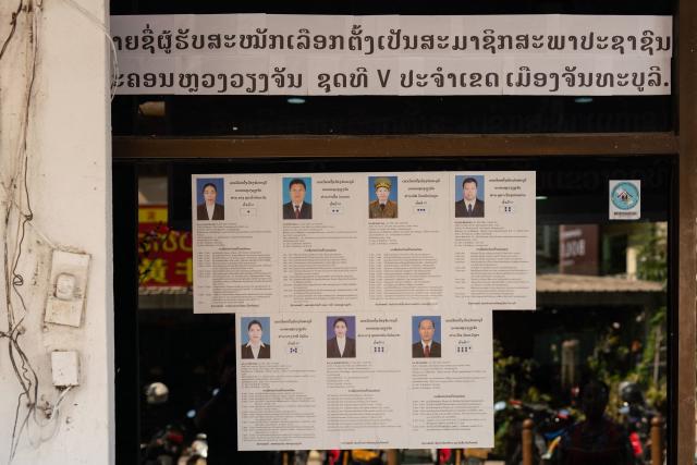 Names and photos of a list of candidates for the Fifth Vientiane People’s Councils in Chanthaburi District are displayed outside a village office ahead of the election in Vientiane on February 19, 2026. The February 22 election will see 243 candidates contest 175 seats after being pre-selected by the ruling communist party. The Southeast Asian nation has no opposition parties, no fully independent news outlets, and the ruling Lao People's Revolutionary Party has held power for more than 50 years. (Photo by AFP)
