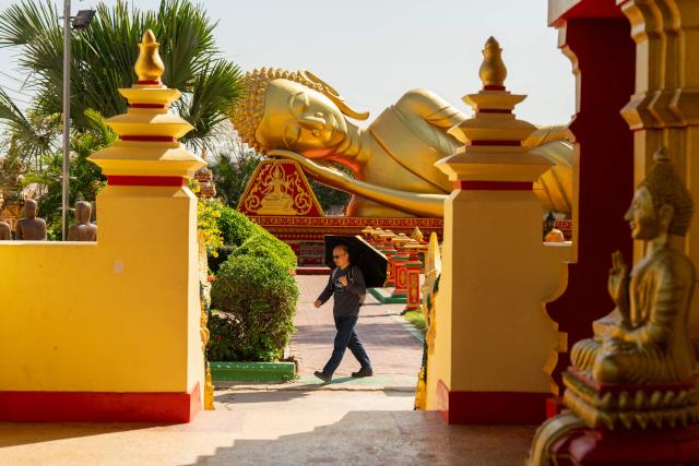 TOPSHOT - A man walks in the grounds of the Thatluang Stupa in Vientiane on February 19, 2026. (Photo by AFP)