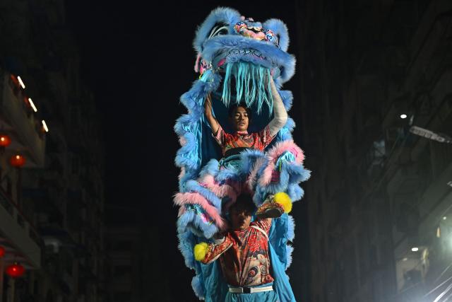 TOPSHOT - Lion dancers compete during a lion and dragon dance competition to mark the Lunar New Year in the Chinatown area of Yangon on February 19, 2026. (Photo by Sai Aung MAIN / AFP)
