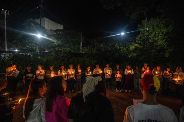 Relatives of political prisoners light candles during a vigil outside after a debate on an amnesty bill proposed by Venezuela’s interim president Delcy Rodriguez, outside El Rodeo I prison in Guatire, Miranda state, Venezuela, on February 20, 2026. On February 19, Venezuela's Parliament unanimously approved a historic amnesty law that is expected to lead to the release of hundreds of political prisoners after 27 years of Chavismo. (Photo by Maryorin Mendez / AFP)
