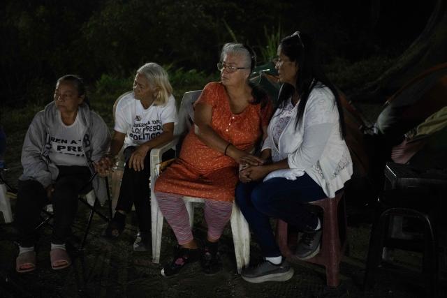 Relatives of political prisoners light candles during a vigil outside after a debate on an amnesty bill proposed by Venezuela’s interim president Delcy Rodriguez, outside El Rodeo I prison in Guatire, Miranda state, Venezuela, on February 20, 2026. On February 19, Venezuela's Parliament unanimously approved a historic amnesty law that is expected to lead to the release of hundreds of political prisoners after 27 years of Chavismo. (Photo by Maryorin Mendez / AFP)