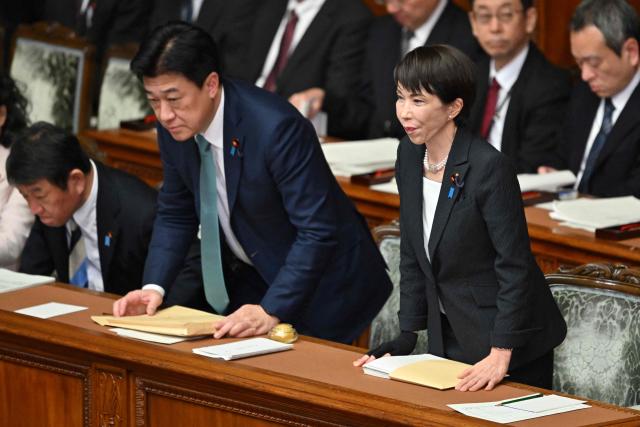 Japan's Prime Minister Sanae Takaichi (R), Chief Cabinet Secretary Minoru Kihara (C) and Foreign Minister Toshimitsu Motegi (L) leave after the House of Representatives plenary session in Tokyo on February 20, 2026. (Photo by Kazuhiro NOGI / AFP)