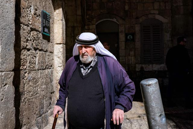 A man walks along an alley in the old city of Jerusalem on the first Friday of the Muslim holy month of Ramadan on February 20, 2026. (Photo by Ilia YEFIMOVICH / AFP)