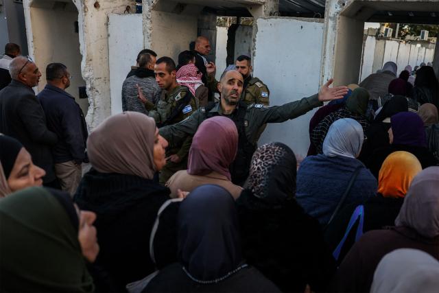 Palestinian Muslims gather at a checkpoint in the occupied West Bank city of Ramallah on February 20, 2026, to enter Jerusalem on their way to Al-Aqsa Mosque for the first Friday noon prayers of the Islamic holy month of Ramadan. (Photo by HAZEM BADER / AFP)