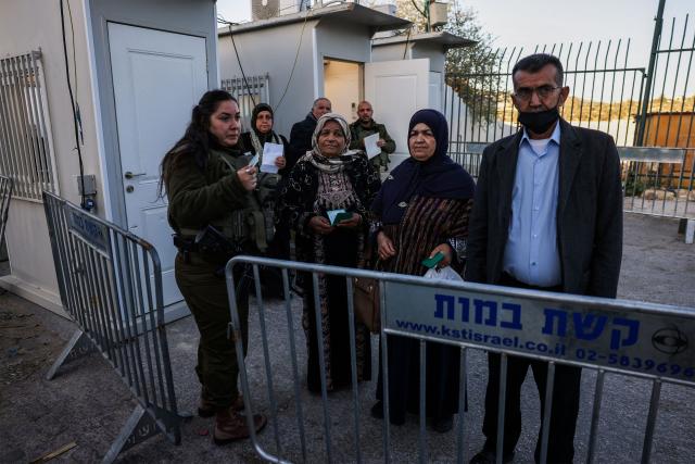 Palestinian Muslims gather at a checkpoint in the occupied West Bank city of Ramallah on February 20, 2026, to enter Jerusalem on their way to Al-Aqsa Mosque for the first Friday noon prayers of the Islamic holy month of Ramadan. (Photo by HAZEM BADER / AFP)