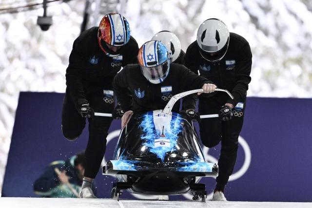 Team Israel including pilot Israel's Adam Edelman (bottom C) take part in the bobsleigh men's 4-man training session at Cortina Sliding Centre during the Milano Cortina 2026 Winter Olympic Games in Cortina d'Ampezzo on February 20, 2026. (Photo by Tiziana FABI / AFP)