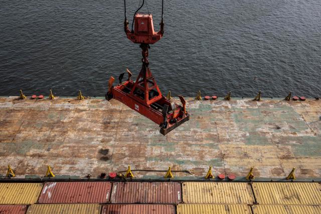 A crane hangs above shipping containers at the Five Star Logistics terminal in Tin Can Island Port, Lagos, on February 19, 2026. (Photo by OLYMPIA DE MAISMONT / AFP)