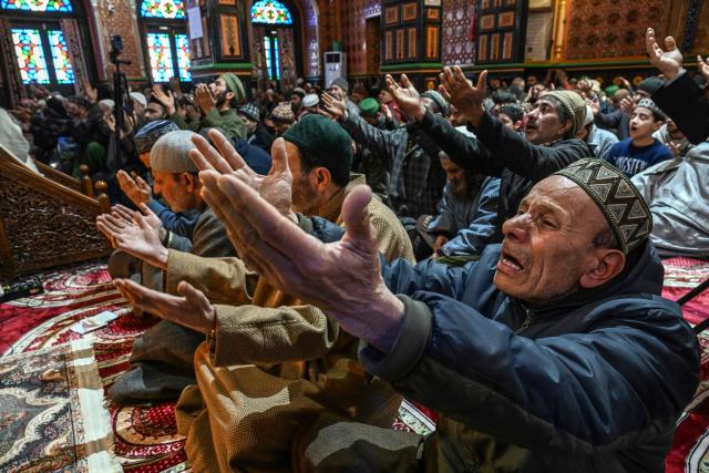 Muslim devotees offer prayers on the first Friday of the Islamic holy month of Ramadan at the Sheikh Syed Abdul Qadir Jeelani shrine in Srinagar on February 20, 2026. (Photo by Tauseef MUSTAFA / AFP)