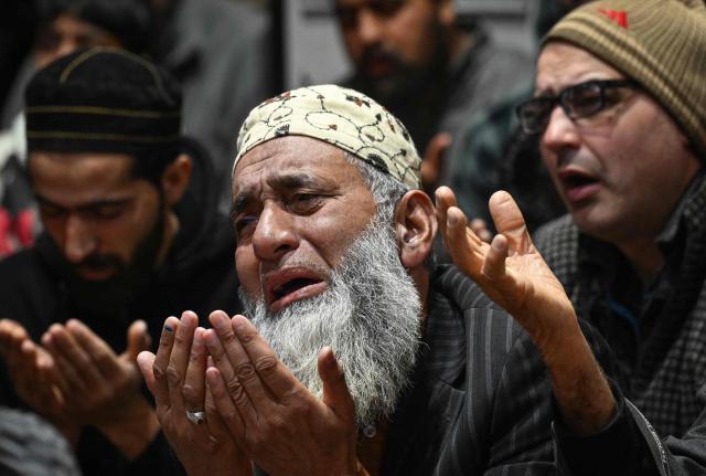 Muslim devotees offer prayers on the first Friday of the Islamic holy month of Ramadan at the Sheikh Syed Abdul Qadir Jeelani shrine in Srinagar on February 20, 2026. (Photo by Tauseef MUSTAFA / AFP)