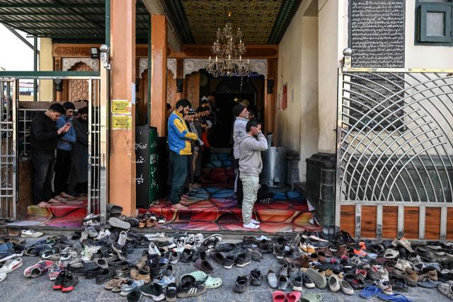Muslim devotees offer prayers on the first Friday of the Islamic holy month of Ramadan at the Sheikh Syed Abdul Qadir Jeelani shrine in Srinagar on February 20, 2026. (Photo by Tauseef MUSTAFA / AFP)