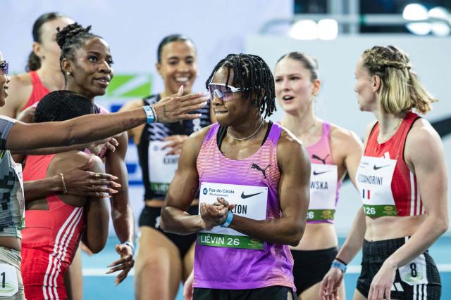 Bahamas' athlete Devynne Charlton (C) celebrates winning in the 60m hurdles Women final at the Athletics meeting "Hauts-de-France Pas-de-Calais" as part of the World Indoor Tour Gold, in Lievin, northern France on February 19, 2026. (Photo by Sameer Al-DOUMY / AFP)