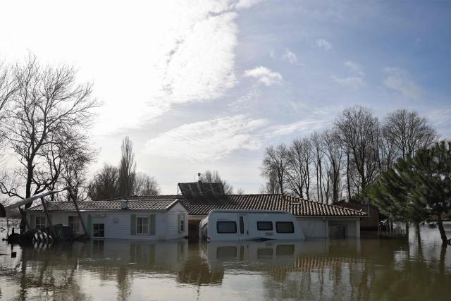 A flooded house and camping car are pictured following heavy rain causing the flooding of the Charente river in Chaniers, southwestern France on February 20, 2026. (Photo by ROMAIN PERROCHEAU / AFP)