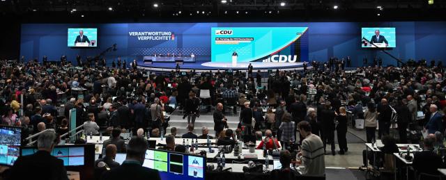 General view as German Chancellor and leader of Germany's Christian Democratic Union (CDU) Friedrich Merz (C and on screens) delivers his speech during the party congress of Germany's Christian Democratic Union (CDU) in Stuttgart, southern Germany, on February 20, 2026. (Photo by THOMAS KIENZLE / AFP)