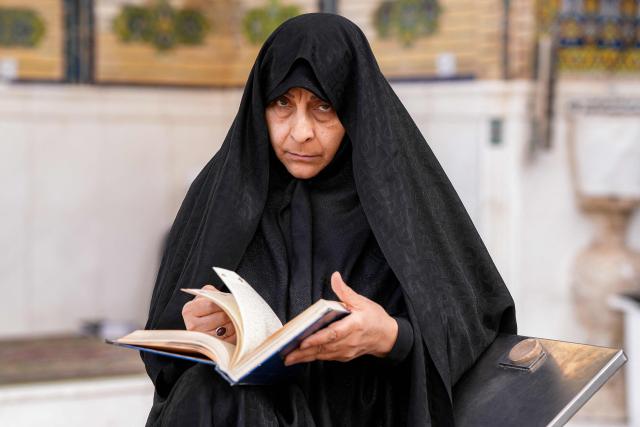 A Muslim worshipper reads from the Koran, Islam's holy book, in Iraq's central holy city of Najaf on February 19, 2026 during the Muslim fasting month of Ramadan. (Photo by Qassem al-KAABI / AFP)