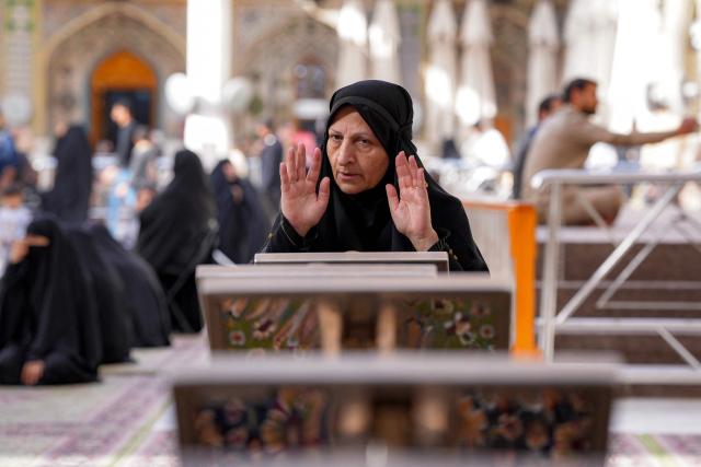 A Muslim worshipper prays in Iraq's central holy city of Najaf on February 19, 2026 during the Muslim fasting month of Ramadan. (Photo by Qassem al-KAABI / AFP)