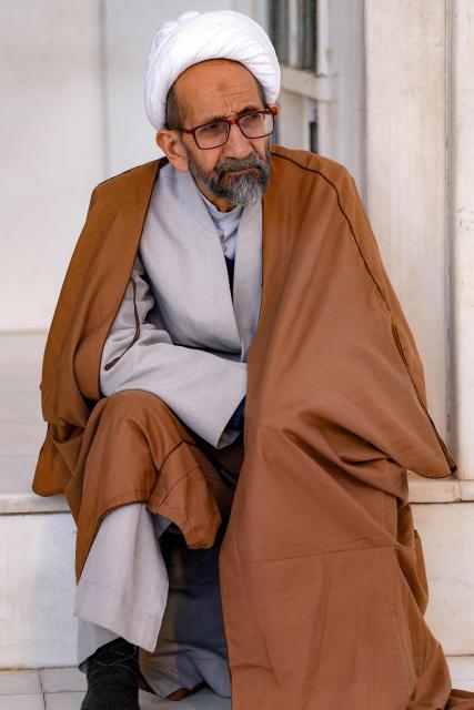 A Shiite Muslim cleric sits in Iraq's central holy city of Najaf on February 19, 2026 during the Muslim fasting month of Ramadan. (Photo by Qassem al-KAABI / AFP)