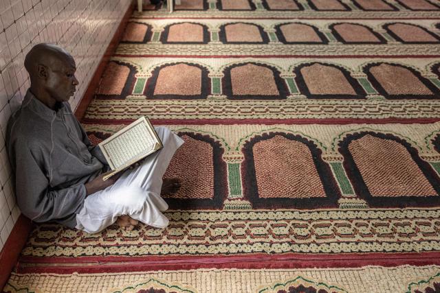 A Muslim worshipper reads from the Quran during the first Friday prayers of the holy month of Ramadan at the Al Maida Mosque Kibera in Nairobi on February 20, 2026. (Photo by SIMON MAINA / AFP)