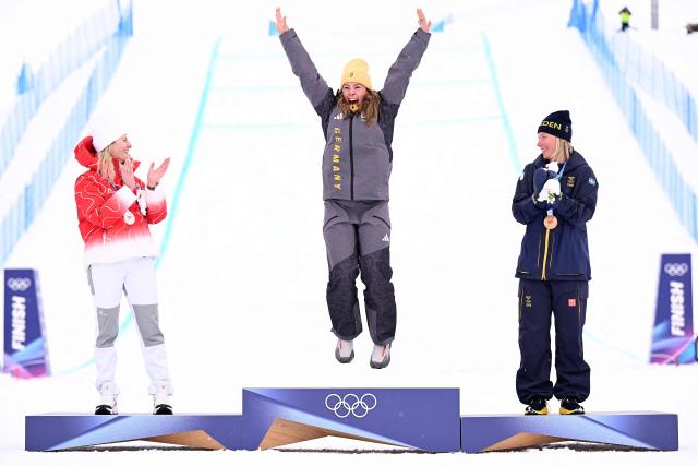 (From L) Silver medallist Switzerland's Fanny Smith, gold medallist Germany's Daniela Maier and bronze medallist Sweden's Sandra Naeslund celebrate on the podium after the freestyle skiing women's ski cross final during the Milano Cortina 2026 Winter Olympic Games at Livigno Snow Park, in Livigno (Valtellina), on February 20, 2026. (Photo by Kirill KUDRYAVTSEV / AFP)