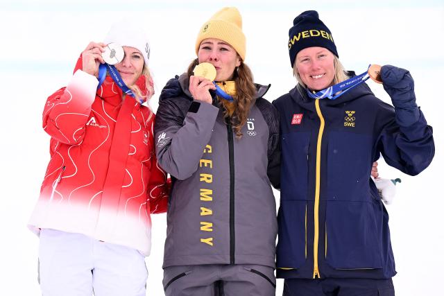 (From L) Silver medallist Switzerland's Fanny Smith, gold medallist Germany's Daniela Maier and bronze medallist Sweden's Sandra Naeslund pose with their medals on the podium after the freestyle skiing women's ski cross final during the Milano Cortina 2026 Winter Olympic Games at Livigno Snow Park, in Livigno (Valtellina), on February 20, 2026. (Photo by Kirill KUDRYAVTSEV / AFP)