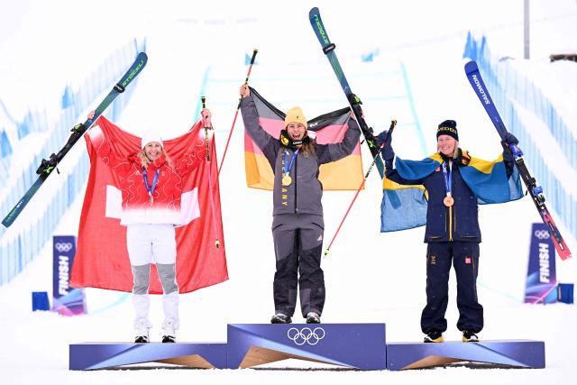 (From L) Silver medallist Switzerland's Fanny Smith, gold medallist Germany's Daniela Maier and bronze medallist Sweden's Sandra Naeslund pose on the podium after the freestyle skiing women's ski cross final during the Milano Cortina 2026 Winter Olympic Games at Livigno Snow Park, in Livigno (Valtellina), on February 20, 2026. (Photo by Kirill KUDRYAVTSEV / AFP)
