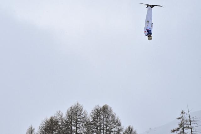 China's Wang Xindi competes in the freestyle skiing men's aerials final 1 during the Milano Cortina 2026 Winter Olympic Games at Livigno Aerials & Moguls Park, in Livigno (Valtellina), on February 20, 2026. (Photo by Jeff PACHOUD / AFP)
