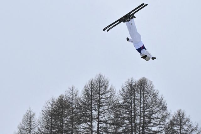 China's Wang Xindi competes in the freestyle skiing men's aerials final 1 during the Milano Cortina 2026 Winter Olympic Games at Livigno Aerials & Moguls Park, in Livigno (Valtellina), on February 20, 2026. (Photo by Jeff PACHOUD / AFP)