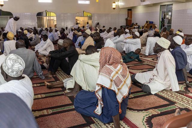Muslim worshippers listen to the Imam's sermon on the first Friday prayers of the holy month of Ramadan at the at the Al Maida Mosque Kibera in Nairobi on February 20, 2026. (Photo by SIMON MAINA / AFP)