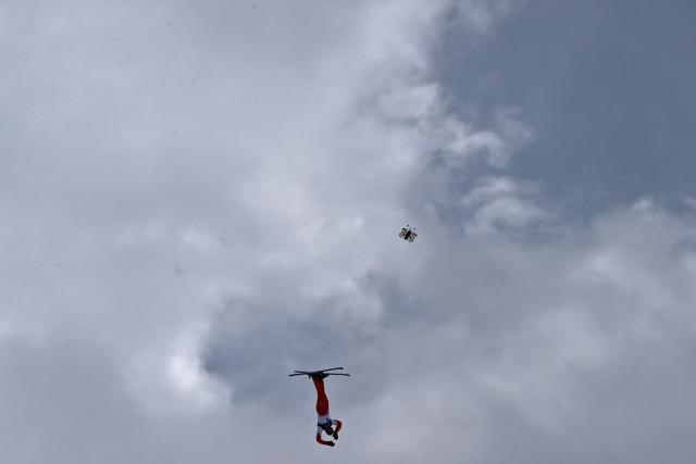 A broadcast drone hovers as Switzerland's Pirmin Werner competes in the freestyle skiing men's aerials final 1 during the Milano Cortina 2026 Winter Olympic Games at Livigno Aerials & Moguls Park, in Livigno (Valtellina), on February 20, 2026. (Photo by Jeff PACHOUD / AFP)