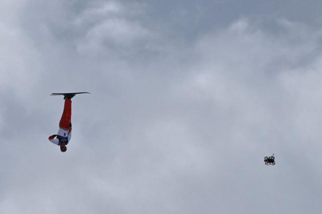 A broadcast drone hovers as Switzerland's Pirmin Werner competes in the freestyle skiing men's aerials final 1 during the Milano Cortina 2026 Winter Olympic Games at Livigno Aerials & Moguls Park, in Livigno (Valtellina), on February 20, 2026. (Photo by Jeff PACHOUD / AFP)