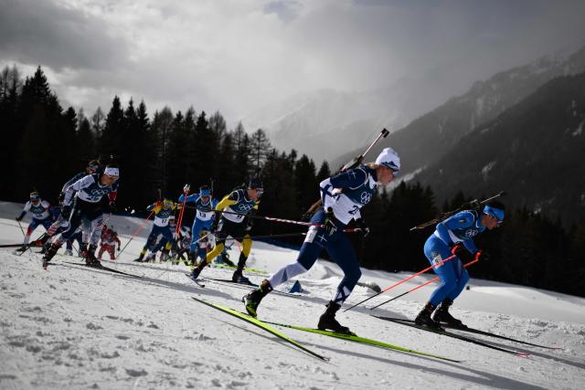 Italy's Tommaso Giacomel (R), Finland's Otto Invenius (2ndR) and France's Fabien Claude (L) compete during the men's biathlon 15km mass start event during the Milano Cortina 2026 Winter Olympic Games at the Anterselva Biathlon Arena (Sudtirol Arena) in Anterselva (Val Pusteria) on February 20, 2026. (Photo by Marco BERTORELLO / AFP)