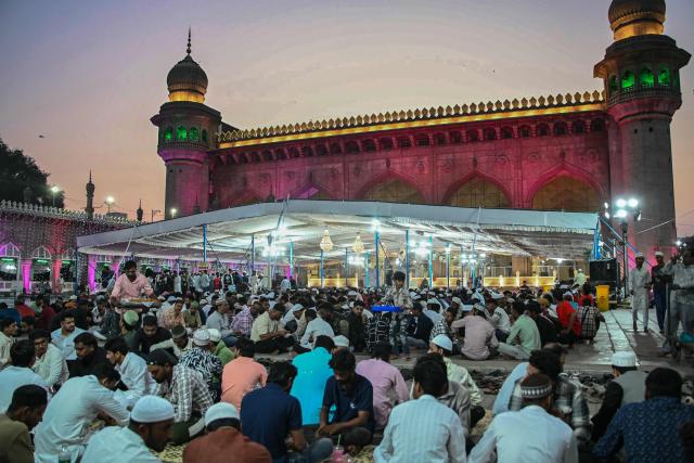 Muslim devotees break their fast on the first Friday of the Islamic holy month of Ramadan at the Mecca Masjid in Hyderabad on February 20, 2026. (Photo by Noah SEELAM / AFP)