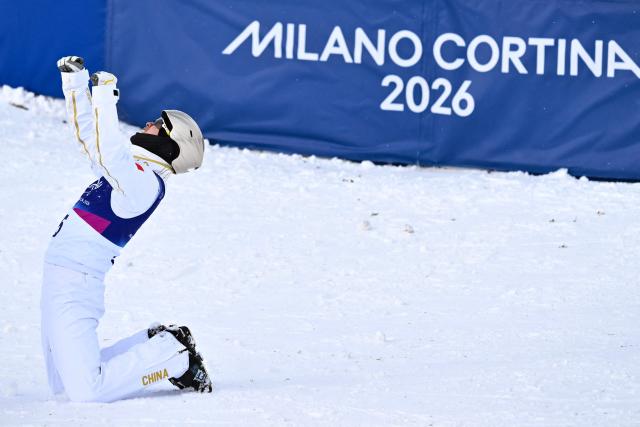 China's Wang Xindi celebrates his victory after winning the freestyle skiing men's aerials final during the Milano Cortina 2026 Winter Olympic Games at Livigno Aerials & Moguls Park, in Livigno (Valtellina), on February 20, 2026. (Photo by Jeff PACHOUD / AFP)