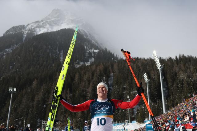 Norway's Johannes Dale-Skjevdal celebrates after he crossed the finish line to win gold during the men's biathlon 15km mass start event during the Milano Cortina 2026 Winter Olympic Games at the Anterselva Biathlon Arena (Sudtirol Arena) in Anterselva (Val Pusteria) on February 20, 2026. (Photo by Odd ANDERSEN / AFP)