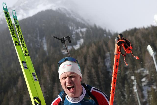 Norway's Johannes Dale-Skjevdal celebrates after he crossed the finish line to win gold during the men's biathlon 15km mass start event during the Milano Cortina 2026 Winter Olympic Games at the Anterselva Biathlon Arena (Sudtirol Arena) in Anterselva (Val Pusteria) on February 20, 2026. (Photo by Odd ANDERSEN / AFP)