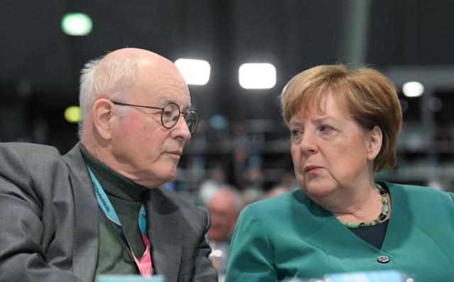 Former German Chancellor and member of the conservative Christian Democratic Union (CDU) Angela Merkel (R) talks with the CDU's former secretary general Volker Kauder as they attend the party congress of Germany's Christian Democratic Union (CDU) in Stuttgart, southern Germany, on February 20, 2026. (Photo by THOMAS KIENZLE / AFP)