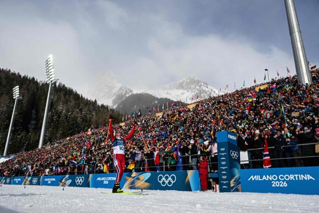 Norway's Johannes Dale-Skjevdal celebrates as he crosses the finish line to win gold during the men's biathlon 15km mass start event during the Milano Cortina 2026 Winter Olympic Games at the Anterselva Biathlon Arena (Sudtirol Arena) in Anterselva (Val Pusteria) on February 20, 2026. (Photo by Odd Andersen / AFP)