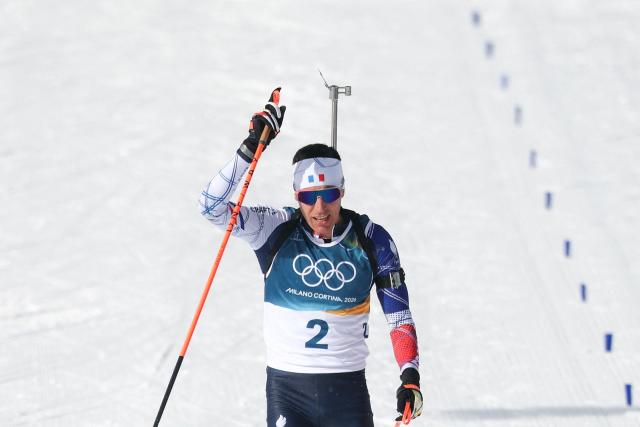 France's Quentin Fillon Maillet celebrates after he crossed the finish line to win bronze during the men's biathlon 15km mass start event during the Milano Cortina 2026 Winter Olympic Games at the Anterselva Biathlon Arena (Sudtirol Arena) in Anterselva (Val Pusteria) on February 20, 2026. (Photo by FRANCK FIFE / AFP)