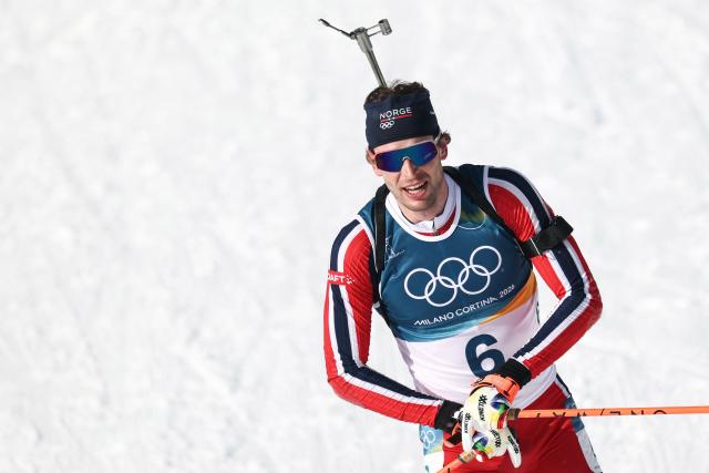 Norway's Sturla Holm Laegreid celebrates after he crossed the finish line to win silver during the men's biathlon 15km mass start event during the Milano Cortina 2026 Winter Olympic Games at the Anterselva Biathlon Arena (Sudtirol Arena) in Anterselva (Val Pusteria) on February 20, 2026. (Photo by FRANCK FIFE / AFP)