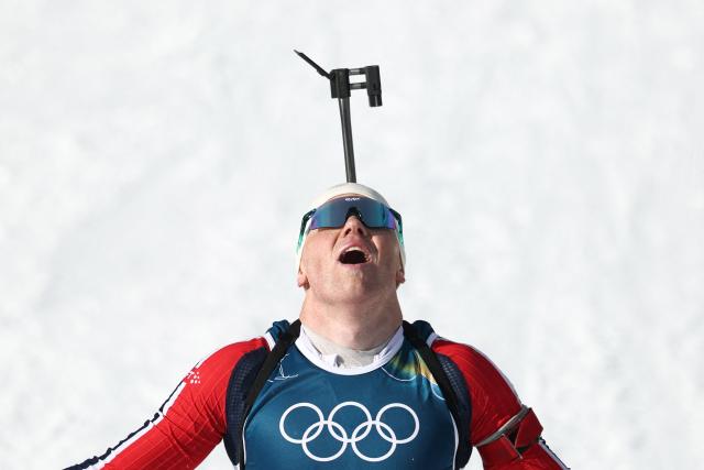 Norway's Johannes Dale-Skjevdal celebrates as he crosses the finish line to win gold during the men's biathlon 15km mass start event during the Milano Cortina 2026 Winter Olympic Games at the Anterselva Biathlon Arena (Sudtirol Arena) in Anterselva (Val Pusteria) on February 20, 2026. (Photo by FRANCK FIFE / AFP)
