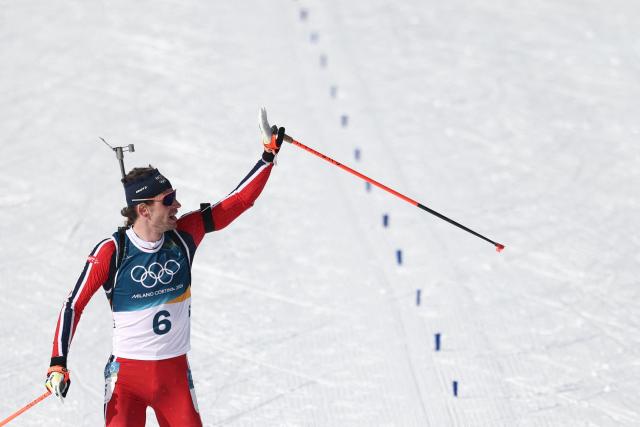 Norway's Sturla Holm Laegreid celebrates towards the public before crossing the finish line to win silver during the men's biathlon 15km mass start event during the Milano Cortina 2026 Winter Olympic Games at the Anterselva Biathlon Arena (Sudtirol Arena) in Anterselva (Val Pusteria) on February 20, 2026. (Photo by FRANCK FIFE / AFP)