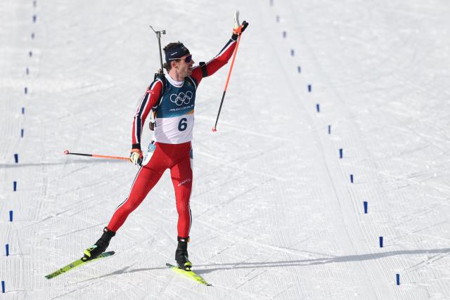 Norway's Sturla Holm Laegreid celebrates towards the public before crossing the finish line to win silver during the men's biathlon 15km mass start event during the Milano Cortina 2026 Winter Olympic Games at the Anterselva Biathlon Arena (Sudtirol Arena) in Anterselva (Val Pusteria) on February 20, 2026. (Photo by FRANCK FIFE / AFP)