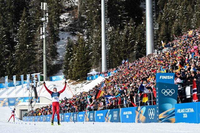 Norway's Johannes Dale-Skjevdal celebrates before he crosses the finish line to win gold during the men's biathlon 15km mass start event during the Milano Cortina 2026 Winter Olympic Games at the Anterselva Biathlon Arena (Sudtirol Arena) in Anterselva (Val Pusteria) on February 20, 2026. (Photo by Odd ANDERSEN / AFP)