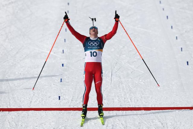 Norway's Johannes Dale-Skjevdal celebrates as he crosses the finish line to win gold during the men's biathlon 15km mass start event during the Milano Cortina 2026 Winter Olympic Games at the Anterselva Biathlon Arena (Sudtirol Arena) in Anterselva (Val Pusteria) on February 20, 2026. (Photo by FRANCK FIFE / AFP)