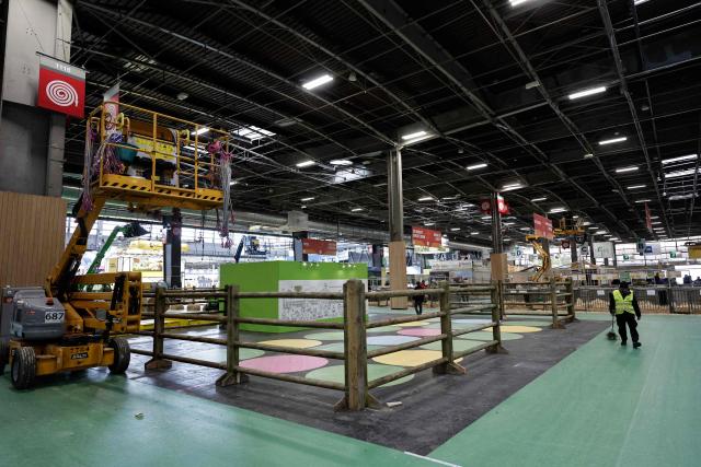 An employee works at the International Agricultural Show on the eve of its opening at Paris Expo Porte de Versailles in Paris on February 20, 2026. (Photo by STEPHANE DE SAKUTIN / AFP)