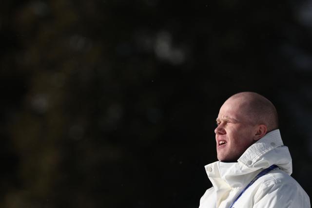 Gold medallist Norway's Johannes Dale-Skjevdal sings his country's national anthem during the podium ceremony of the men's biathlon 15km mass start event during the Milano Cortina 2026 Winter Olympic Games at the Anterselva Biathlon Arena (Sudtirol Arena) in Anterselva (Val Pusteria) on February 20, 2026. (Photo by FRANCK FIFE / AFP)