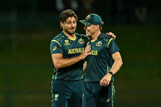 Australia's Marcus Stoinis (L) celebrates with teammate Nathan Ellis after taking the wicket of Oman's Vinayak Shukla during the 2026 ICC Men's T20 Cricket World Cup group stage match between Oman and Australia at Pallekele International Cricket Stadium in Kandy on February 20, 2026. (Photo by Ishara S. KODIKARA / AFP)