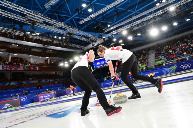 Switzerland's Alina Paetz (R) competes in the curling women's round robin semi-final between USA and Switzerland during the Milano Cortina 2026 Winter Olympic Games at the Cortina Curling Olympic Stadium in Cortina d’Ampezzo on February 20, 2026. (Photo by Stefano RELLANDINI / AFP)