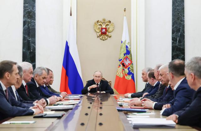 In this pool photograph distributed by the Russian state agency Sputnik, Russia's President Vladimir Putin chairs a Security Council meeting in Moscow on February 20, 2026. (Photo by Vyacheslav PROKOFYEV / POOL / AFP)