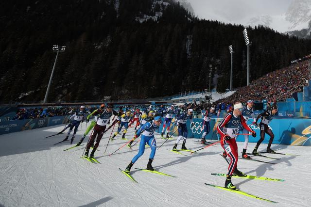 Norway's Johannes Dale-Skjevdal (Front R) and fellow athletes take the start of the men's biathlon 15km mass start event during the Milano Cortina 2026 Winter Olympic Games at the Anterselva Biathlon Arena (Sudtirol Arena) in Anterselva (Val Pusteria) on February 20, 2026. (Photo by Franck FIFE / AFP)